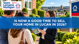Team Lorraine Mulligan banner showing an estate agent discussing the Lucan property market with a couple outside a home, with a tablet and “For Sale” sign visible.