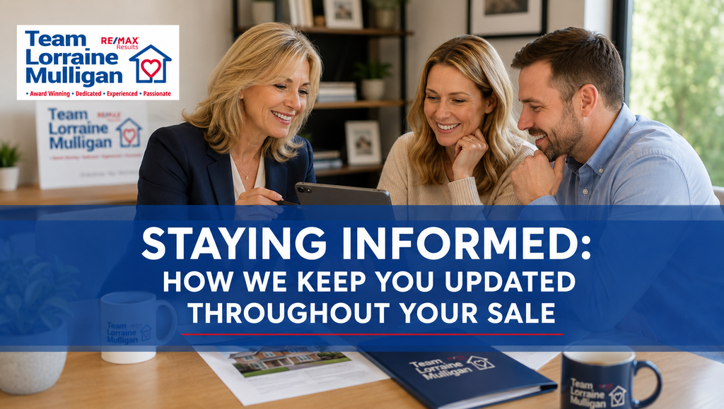 Estate agent Lorraine Mulligan meeting with a couple and reviewing property sale information together on a tablet in a modern office.